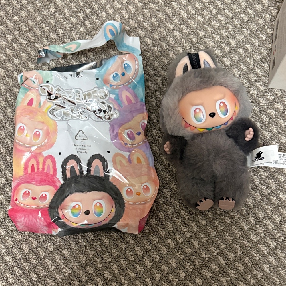 Gray and Black Plush Doll with Colorful Packaging